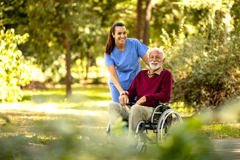 Older adult and family member speaking with a caregiver in a bright assisted living apartment.
